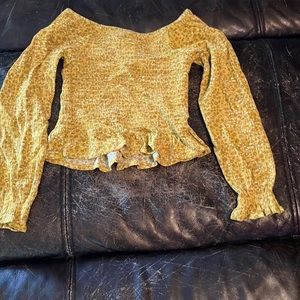 long sleeve crop top shirt and faded blue ripped jeans. The size is a 6X